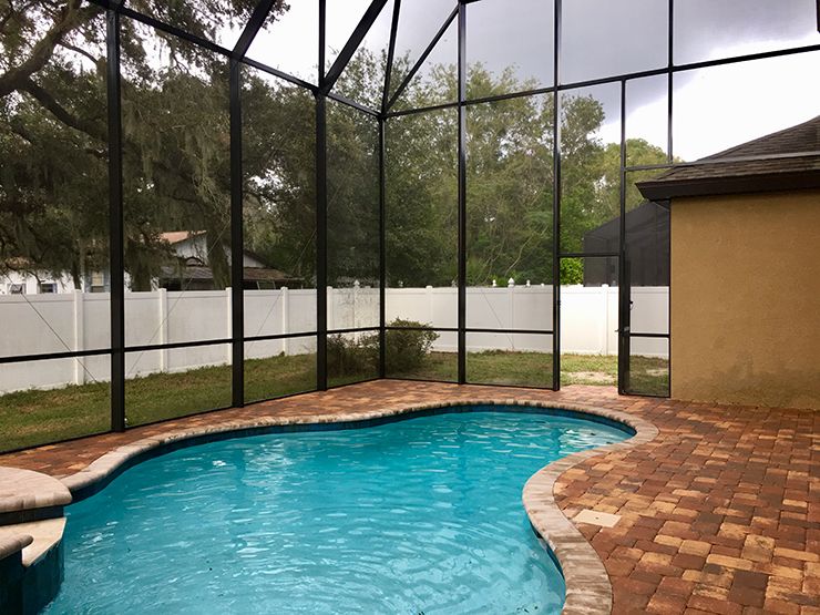 Two story pool enclosure with paver pool deck