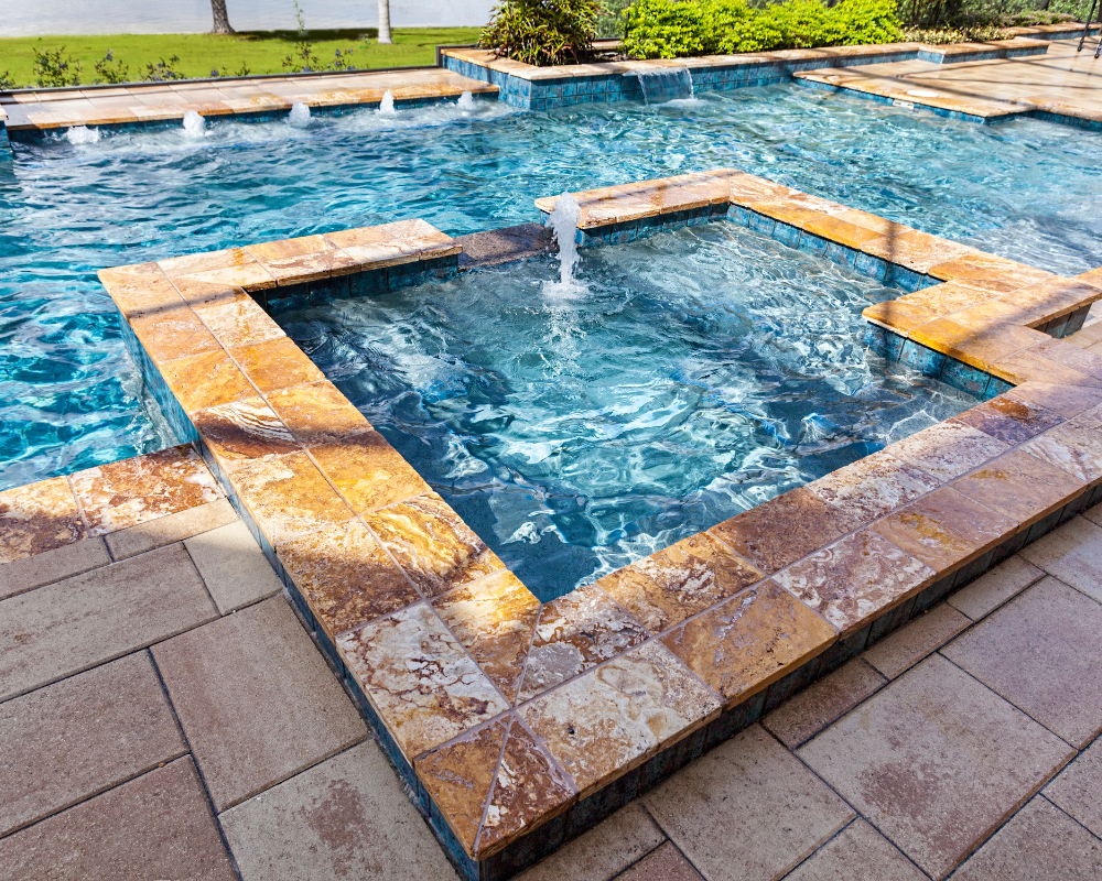 3 GRACO Spa in swimming pool with paver coping and patio.