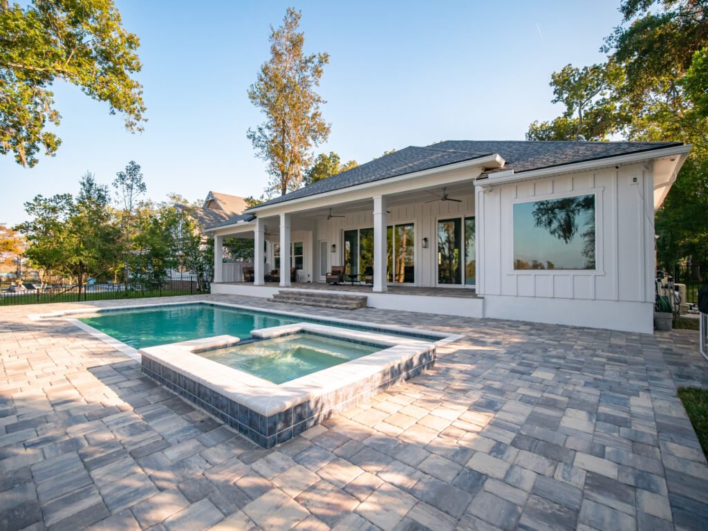 New,Construction,Model,Home,Luxury,Exterior GRACO inground swimmng pool with paver patio surrounding.