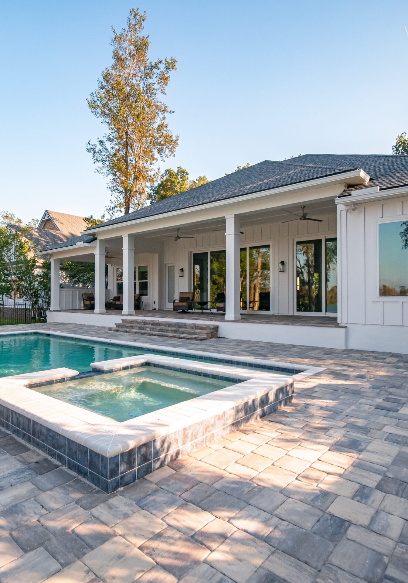 New,Construction,Model,Home,Luxury,Exterior GRACO inground swimmng pool with paver patio surrounding.